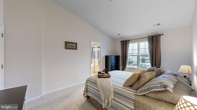 carpeted bedroom with high vaulted ceiling and connected bathroom