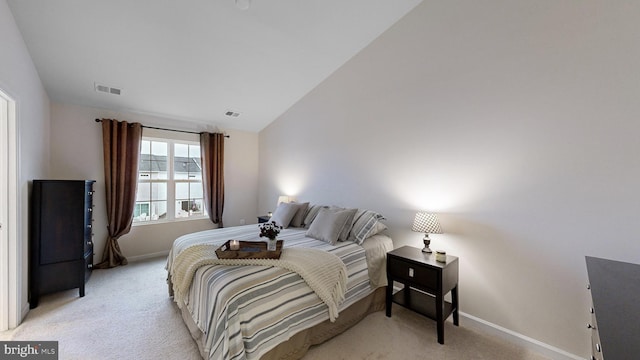 carpeted bedroom with vaulted ceiling