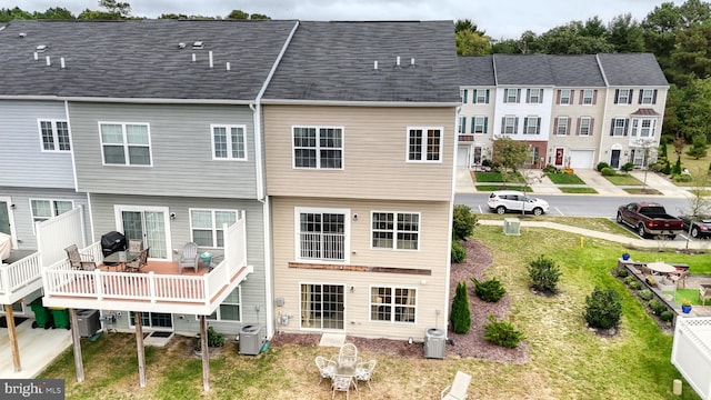 rear view of property featuring a wooden deck and central air condition unit