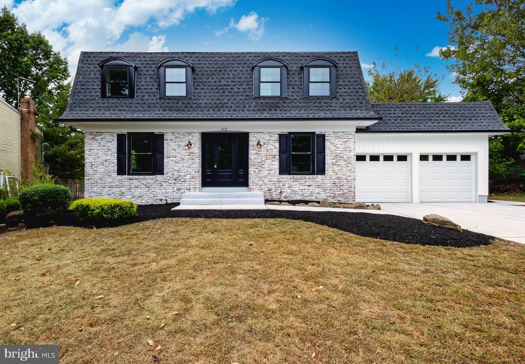 view of front of home with a garage and a front lawn