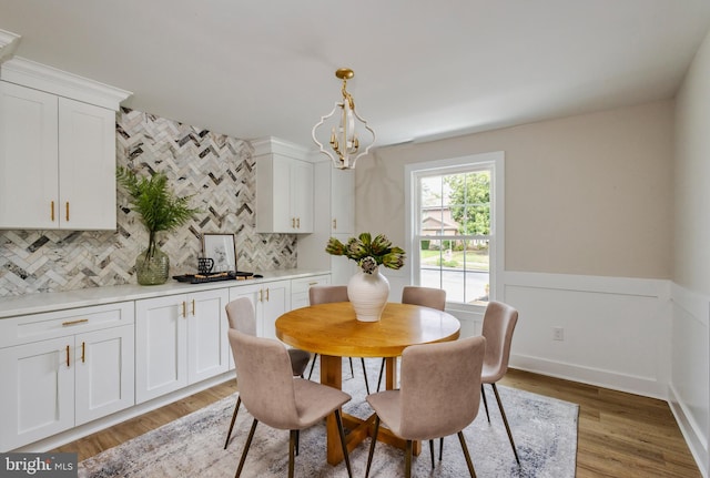 dining area featuring a notable chandelier and dark wood-type flooring