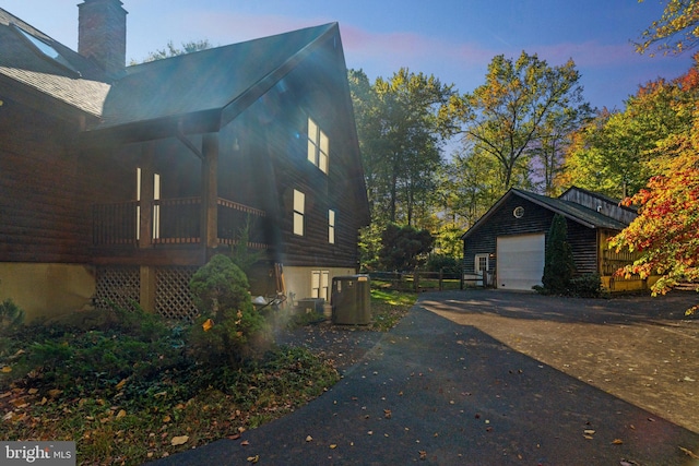 property exterior at dusk featuring cooling unit