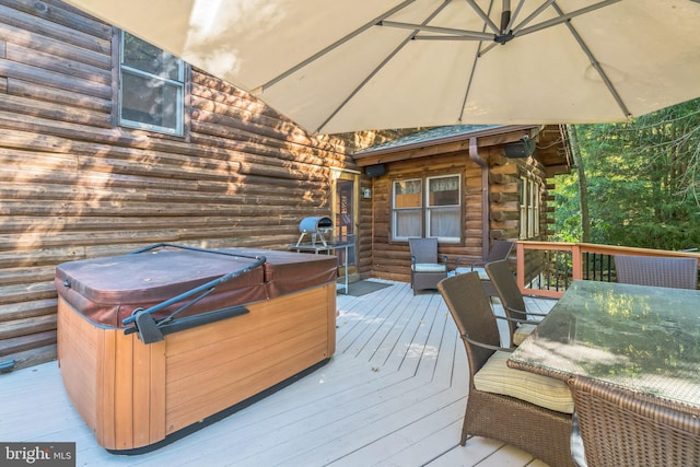 wooden terrace with a hot tub