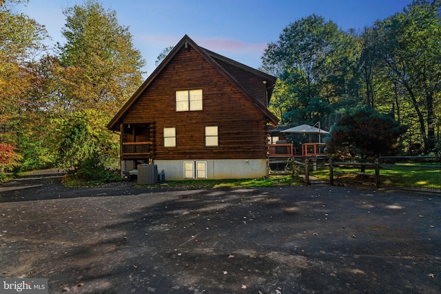 property exterior at dusk featuring central air condition unit