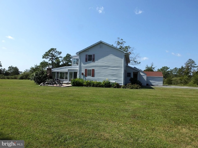 view of property exterior featuring a yard and a patio area