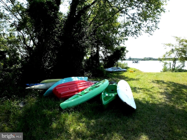 exterior space featuring a water view and a yard