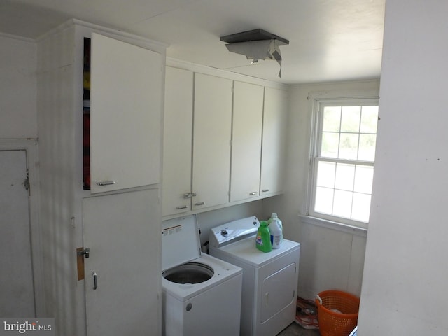 laundry room featuring cabinets and washer and dryer