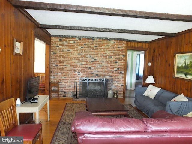 living room featuring wood-type flooring, beam ceiling, and wooden walls