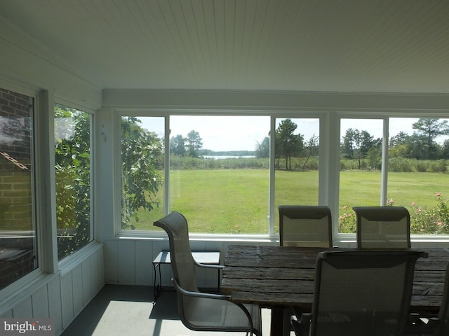 sunroom featuring outdoor dining area