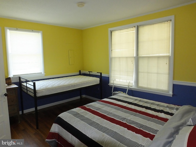 bedroom featuring crown molding and wood finished floors