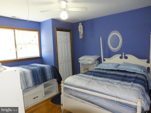 bedroom with ceiling fan and hardwood / wood-style floors