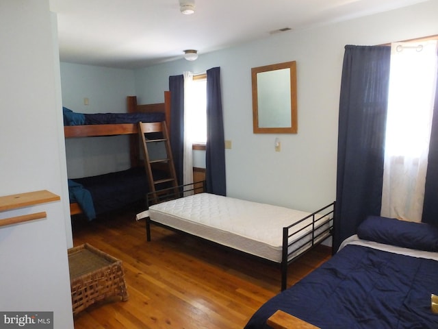 bedroom with visible vents and wood finished floors