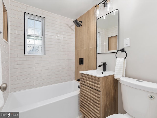 full bathroom with toilet, tiled shower / bath combo, and vanity