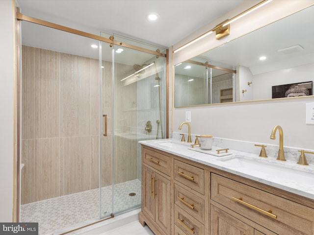 bathroom with walk in shower and vanity