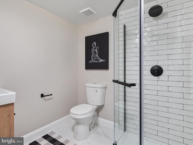 bathroom featuring toilet and an enclosed shower