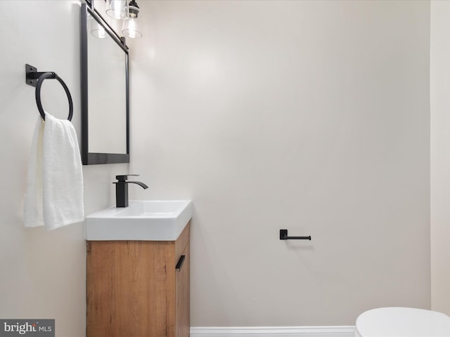 bathroom featuring toilet and vanity