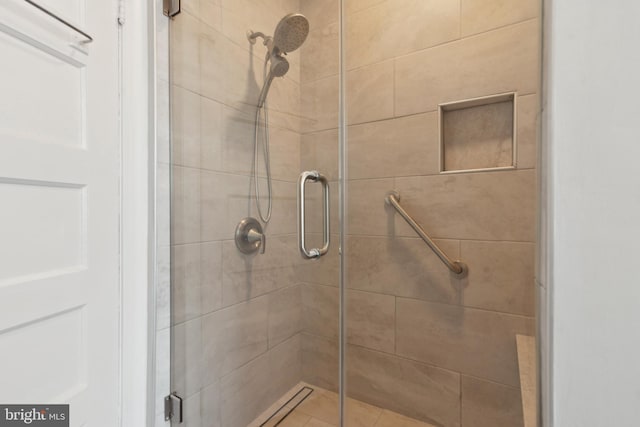 bathroom featuring a shower with door