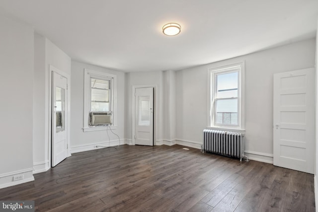 unfurnished room with radiator and dark hardwood / wood-style flooring