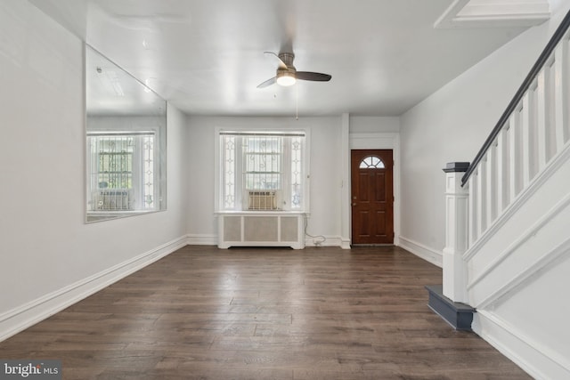 foyer entrance featuring cooling unit, radiator, dark hardwood / wood-style flooring, and ceiling fan