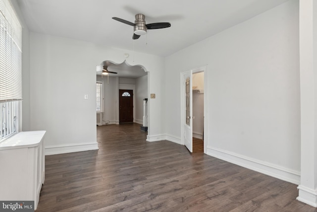 unfurnished room featuring ceiling fan and dark wood-type flooring