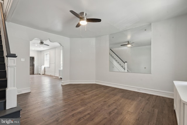 unfurnished room featuring dark wood-type flooring and ceiling fan