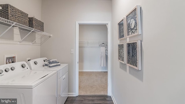 clothes washing area with dark hardwood / wood-style floors and washing machine and dryer