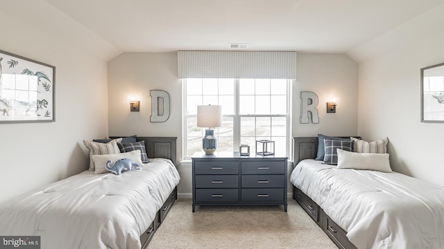 bedroom featuring light colored carpet and vaulted ceiling