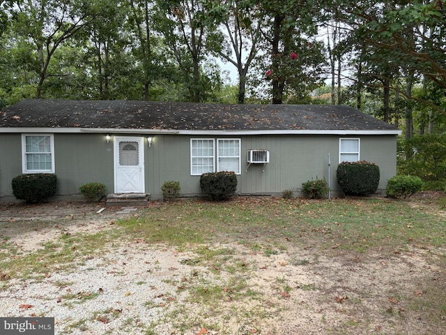 view of front of home with a wall mounted air conditioner