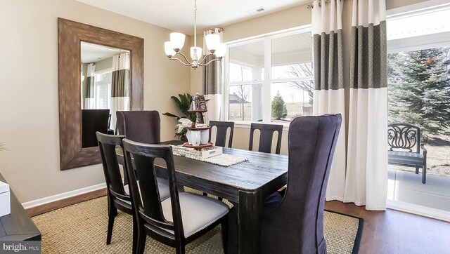 dining area featuring a notable chandelier and hardwood / wood-style floors