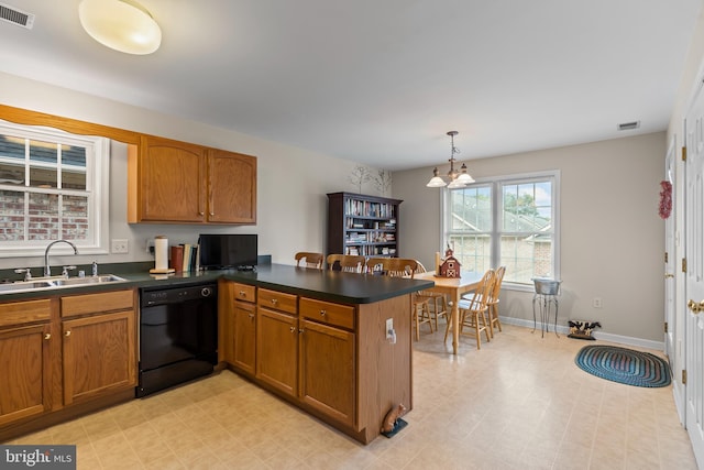 kitchen featuring black dishwasher, a chandelier, sink, kitchen peninsula, and hanging light fixtures