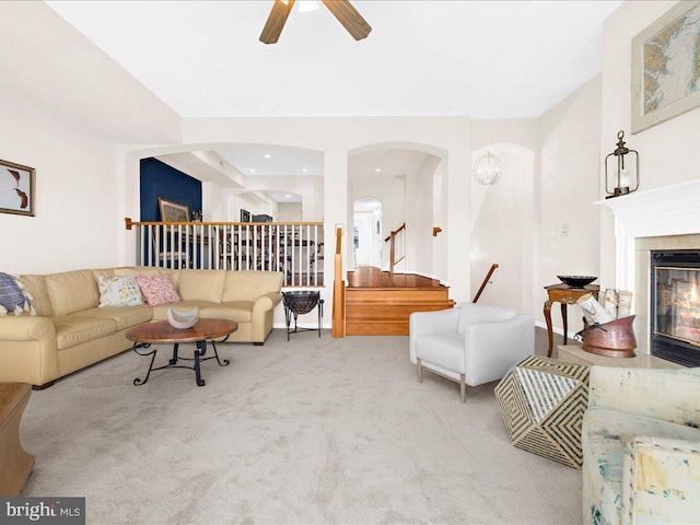 carpeted living room featuring ceiling fan