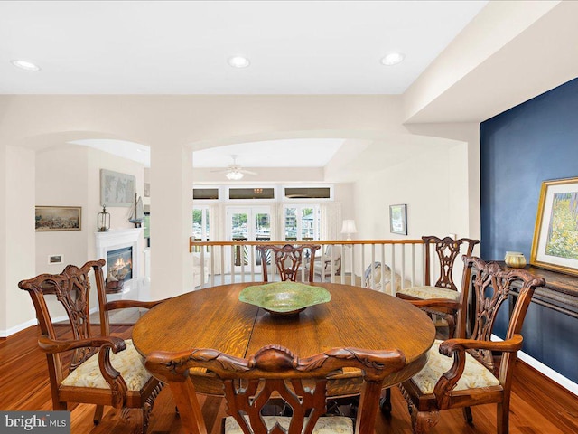 dining area with ceiling fan and hardwood / wood-style flooring