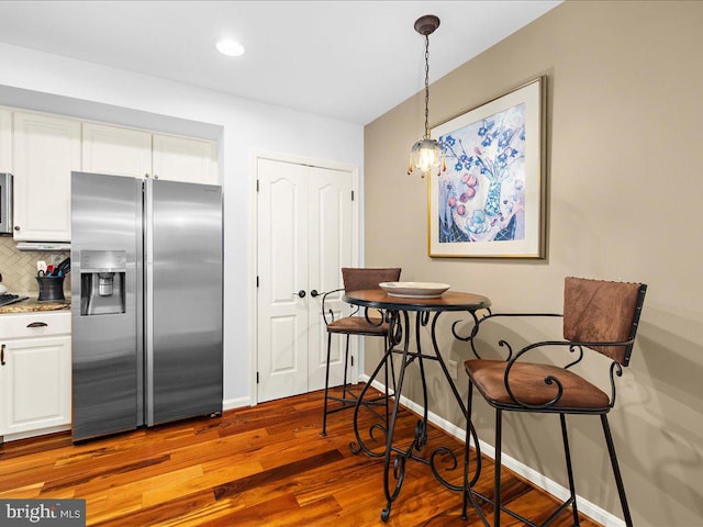 dining space with hardwood / wood-style floors