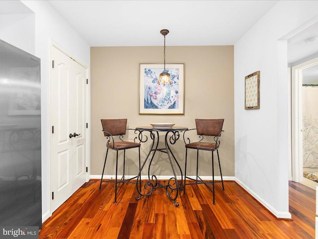 dining space featuring dark hardwood / wood-style flooring