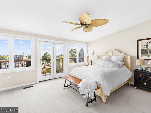 bedroom with access to outside, light carpet, and ceiling fan