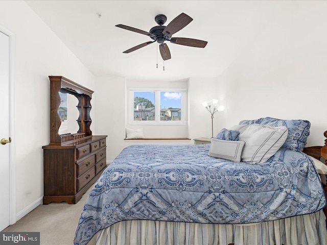 bedroom featuring light carpet and ceiling fan