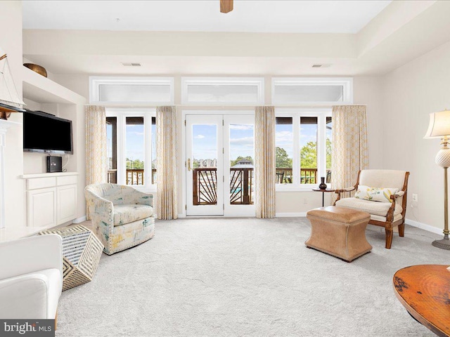 carpeted living room with a healthy amount of sunlight