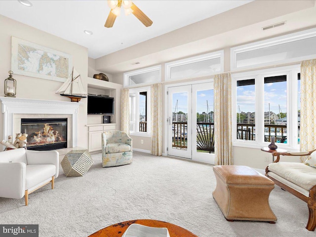 carpeted living room featuring ceiling fan