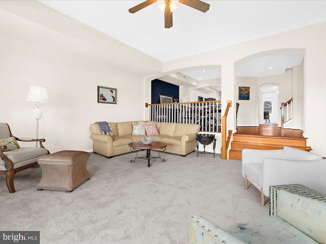 living room featuring ceiling fan and light colored carpet