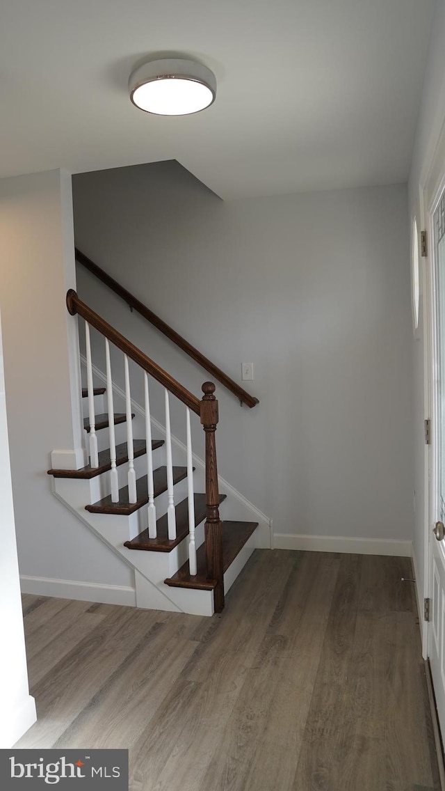 stairs with wood-type flooring