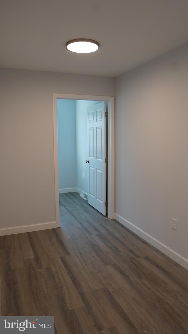 empty room featuring dark wood-type flooring