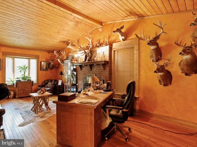 office with wood ceiling, a fireplace, lofted ceiling with beams, and hardwood / wood-style floors