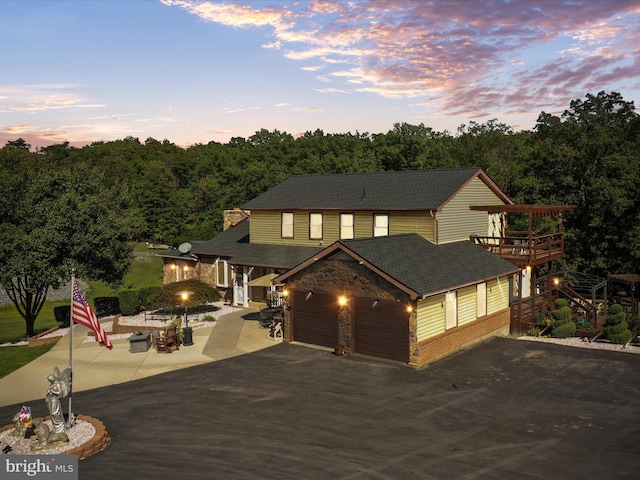 view of front of home featuring a patio area and a garage