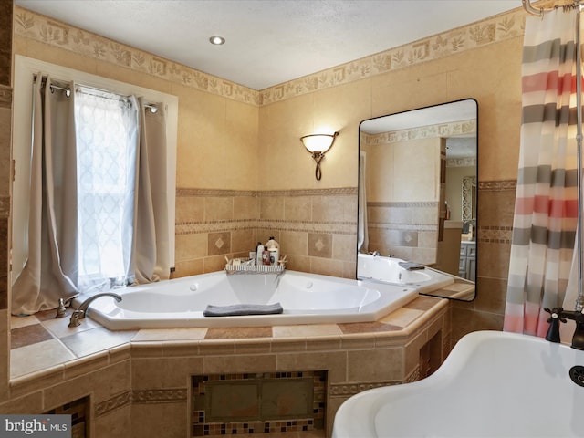 bathroom featuring tile walls, tiled bath, and a wealth of natural light