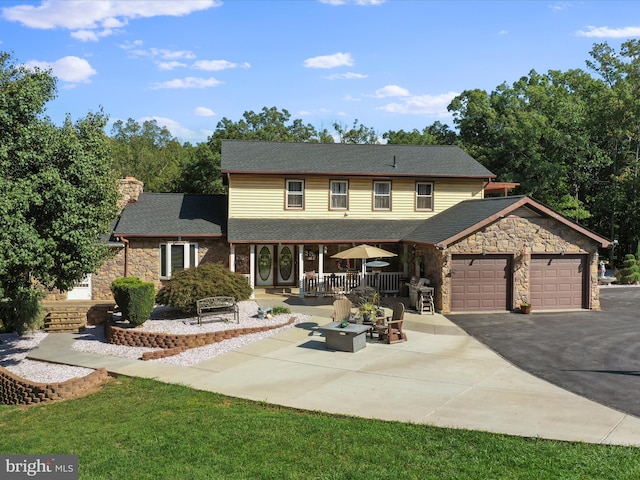 view of front of house with a garage and a front yard