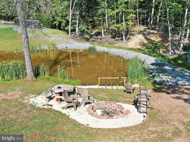 view of yard with a water view, a patio area, and a fire pit