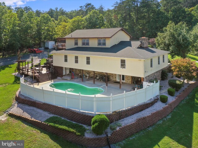 rear view of property with a yard and a patio area