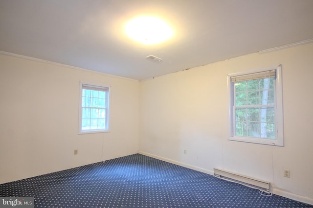 carpeted empty room featuring baseboard heating, ornamental molding, and a wealth of natural light