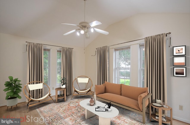 living room featuring lofted ceiling, hardwood / wood-style floors, and ceiling fan