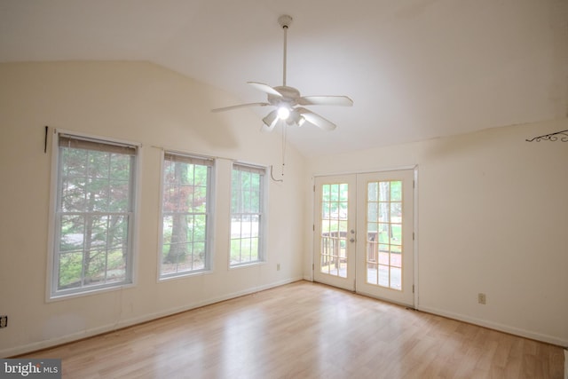 spare room with ceiling fan, vaulted ceiling, french doors, and light hardwood / wood-style floors